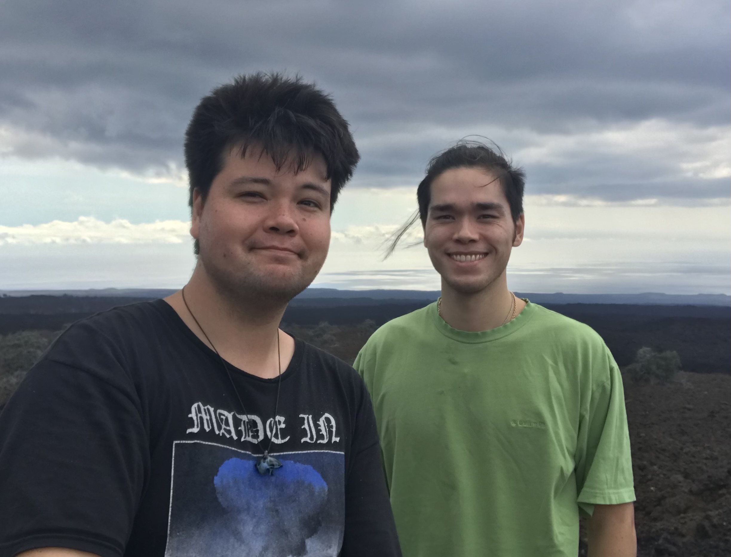 Two brothers together in a volcanic landscape in Hawaiʻi